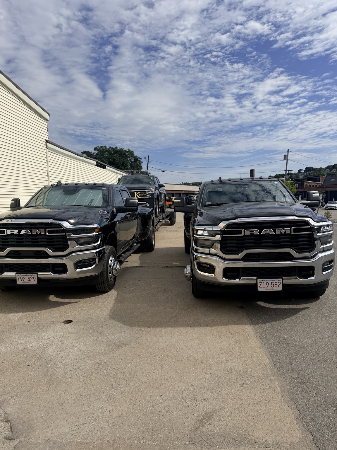 Two Fly Transport RAM heavy-duty pickups parked side by side